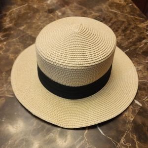 Never worn straw boater style with Black band rim. Adjustable inside.